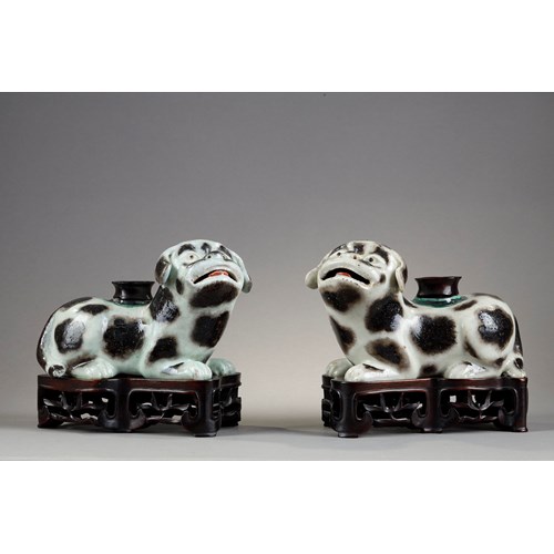 Pair of dogs forming incense stick holders in brown speckled porcelain on beige background